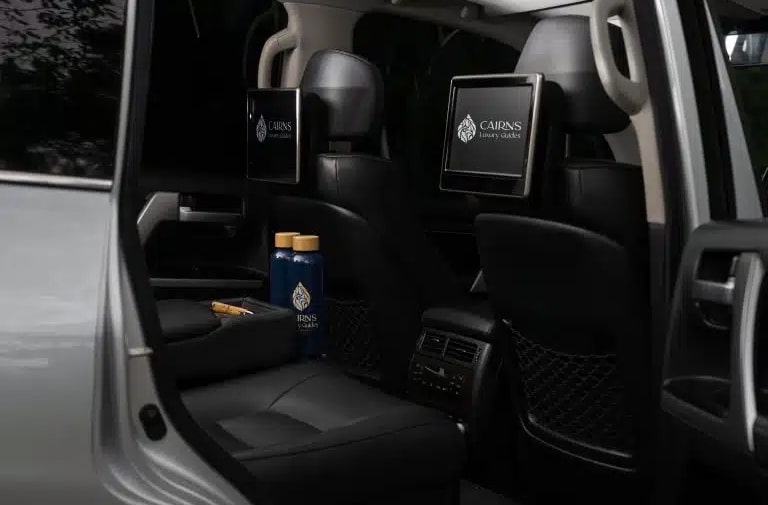 Private luxury transfer vehicle loaded with guests' luggage at Cairns airport